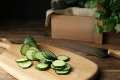 Photo of Slices of fresh ripe cucumber on wooden table