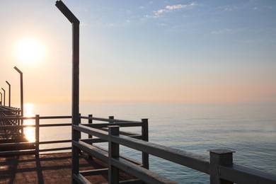 Photo of Picturesque view of pier near sea boat at sunrise