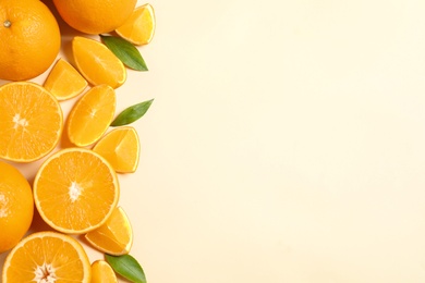 Photo of Flat lay composition with ripe oranges and space for text on color background