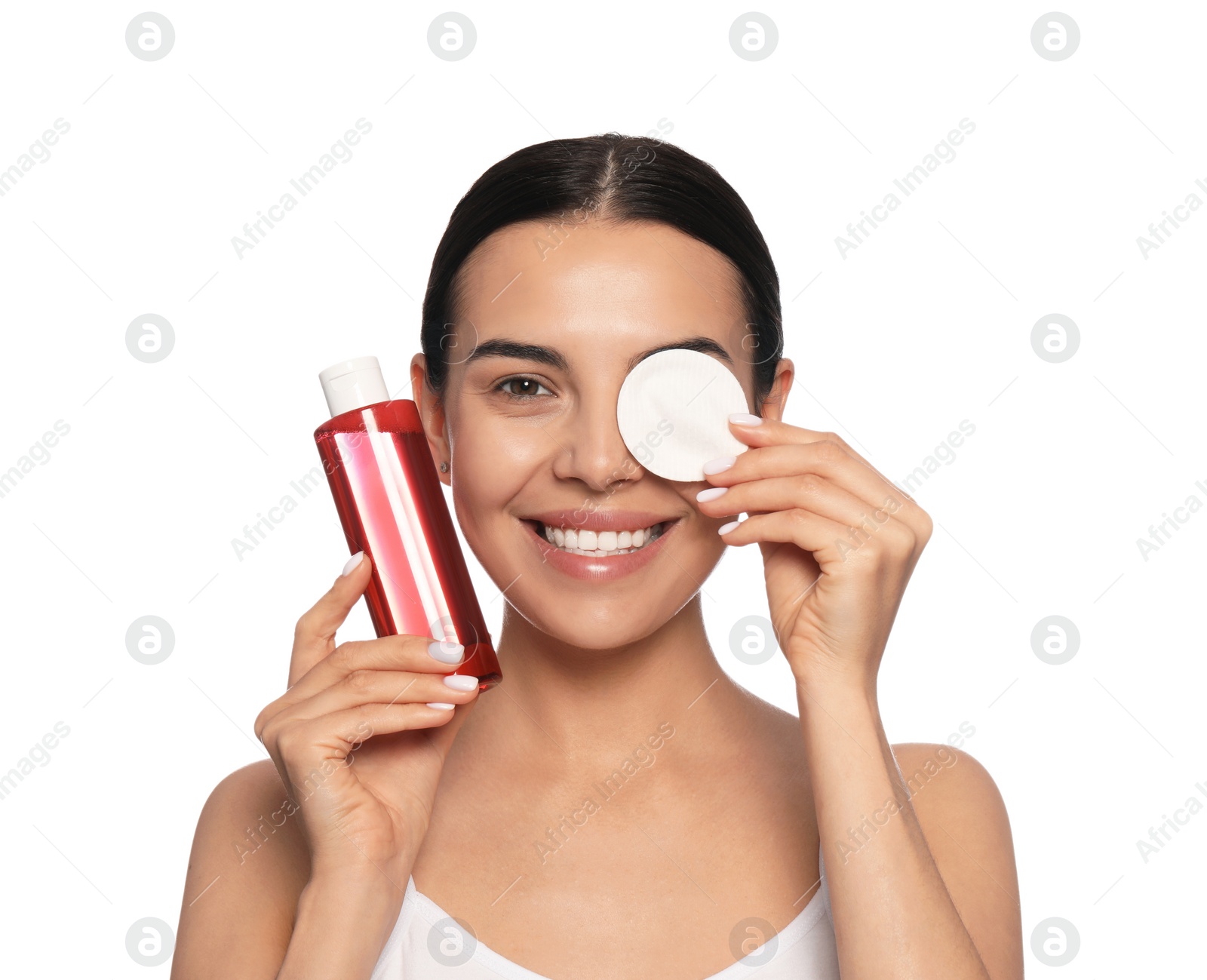 Photo of Young woman using cotton pad with micellar water on white background