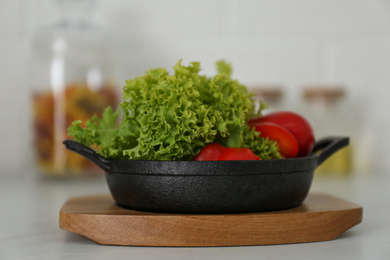 Photo of Portioned frying pan with products on table