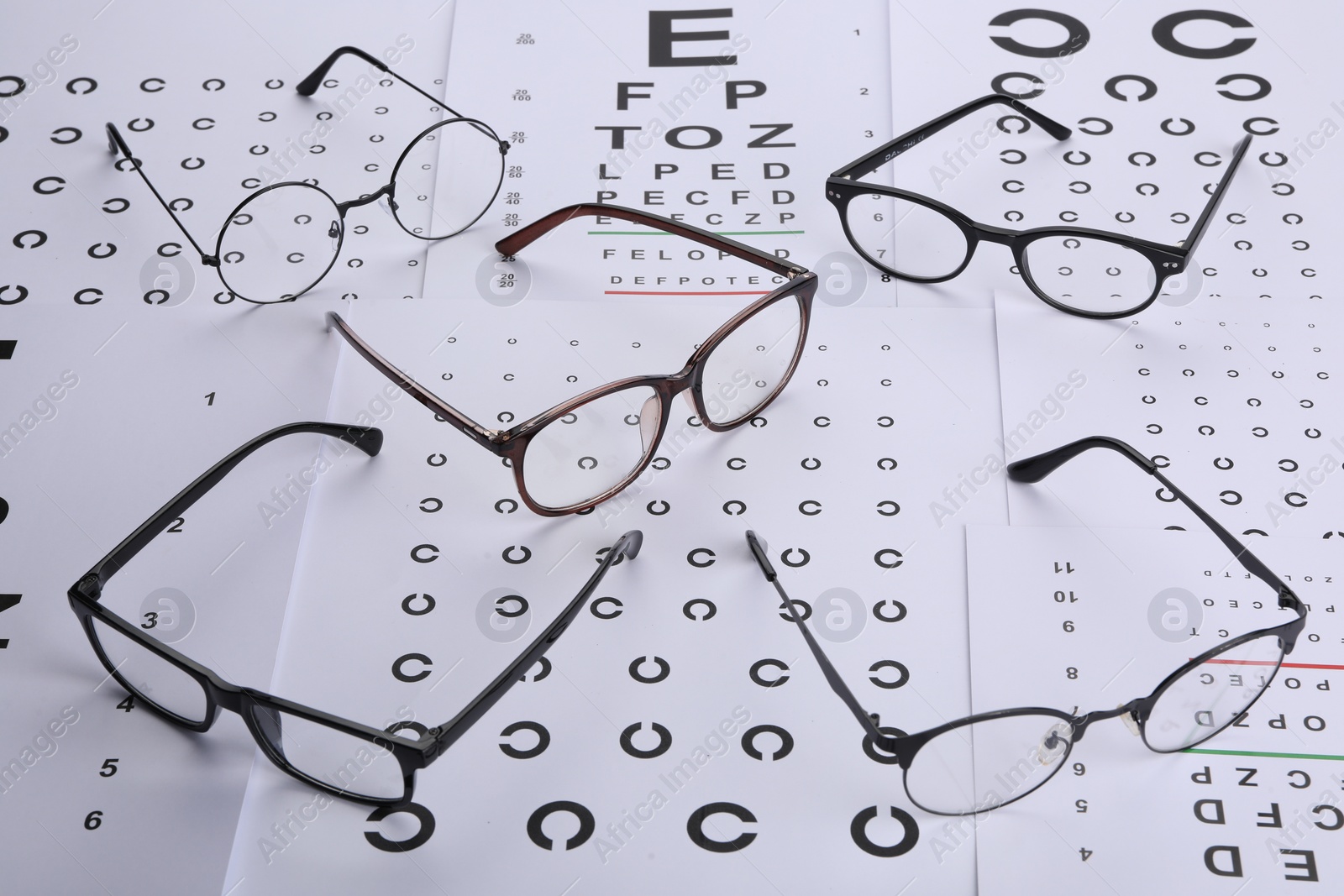 Photo of Vision test charts and glasses on table