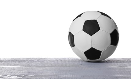 Photo of Football ball on grey wooden table against white background. Space for text