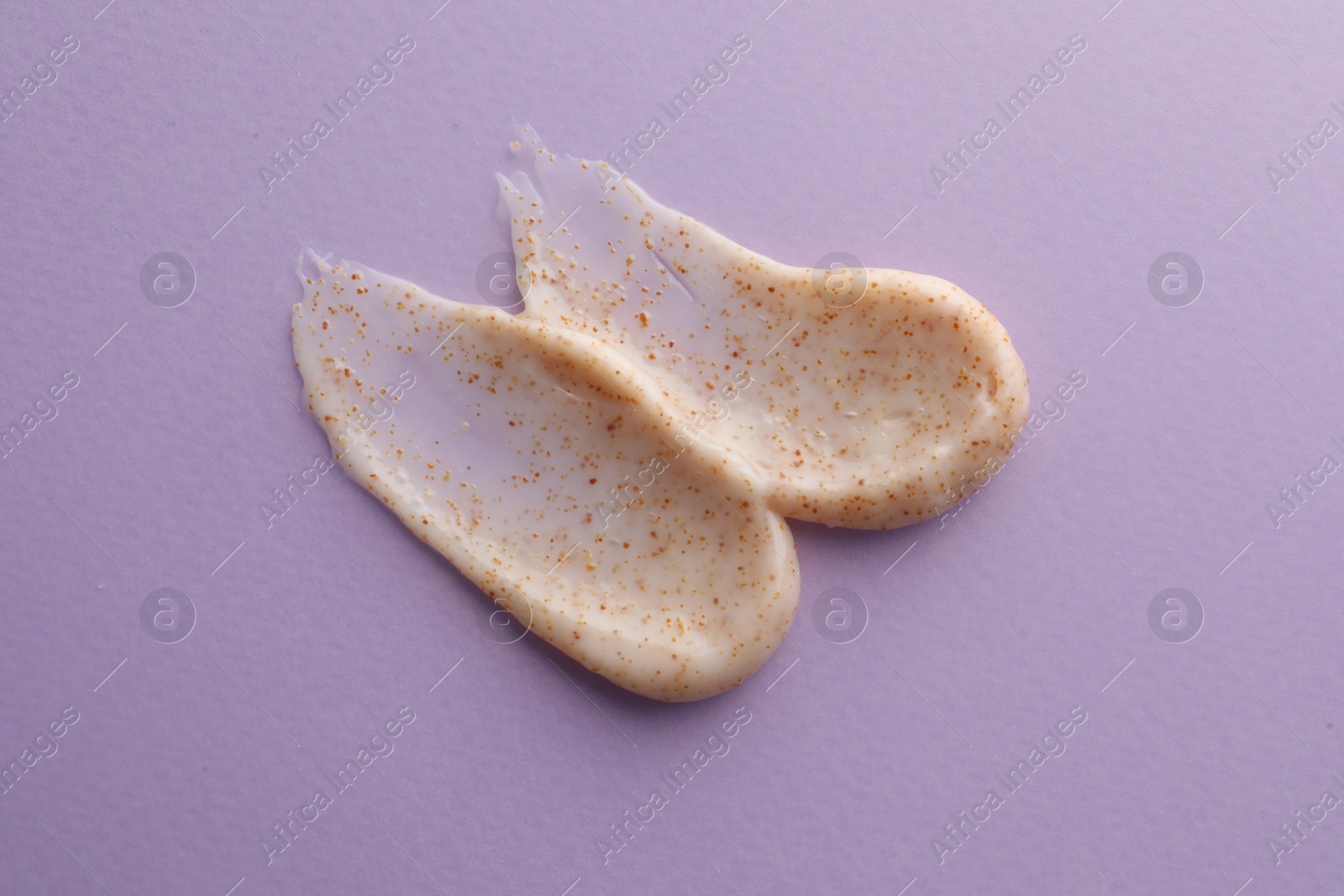 Photo of Sample of natural scrub on violet background, top view