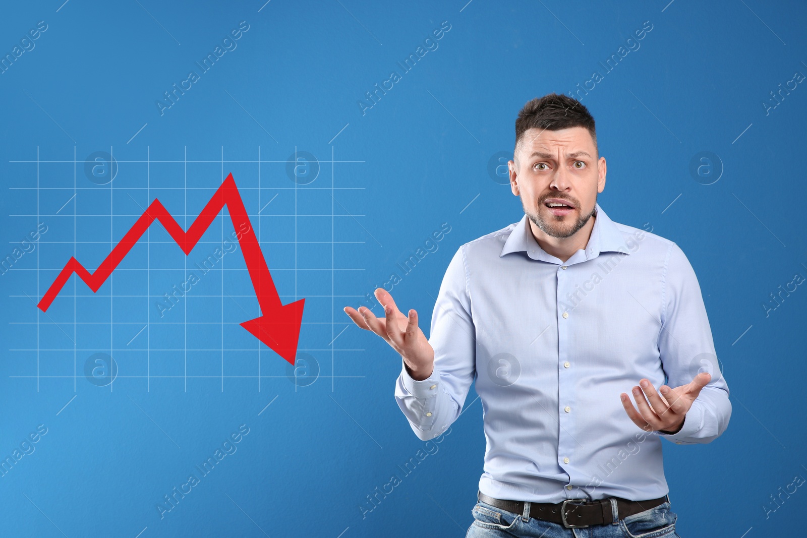 Image of Confused man and illustration of falling down chart on light blue background. Economy recession concept