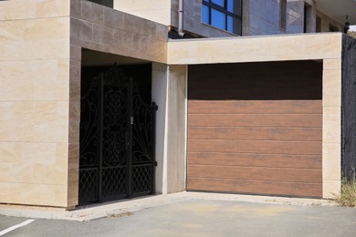 Beautiful building with sectional garage door and iron gate