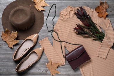 Photo of Fall fashion. Layout of women's outfit on wooden background, top view