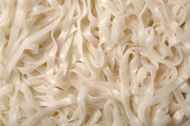 Photo of Delicious rice noodles as background, top view