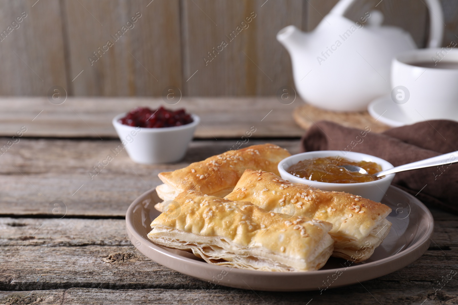 Photo of Delicious puff pastry served on wooden table