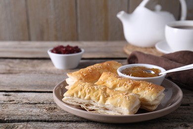 Photo of Delicious puff pastry served on wooden table