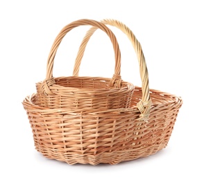 Photo of Two decorative wicker baskets on white background