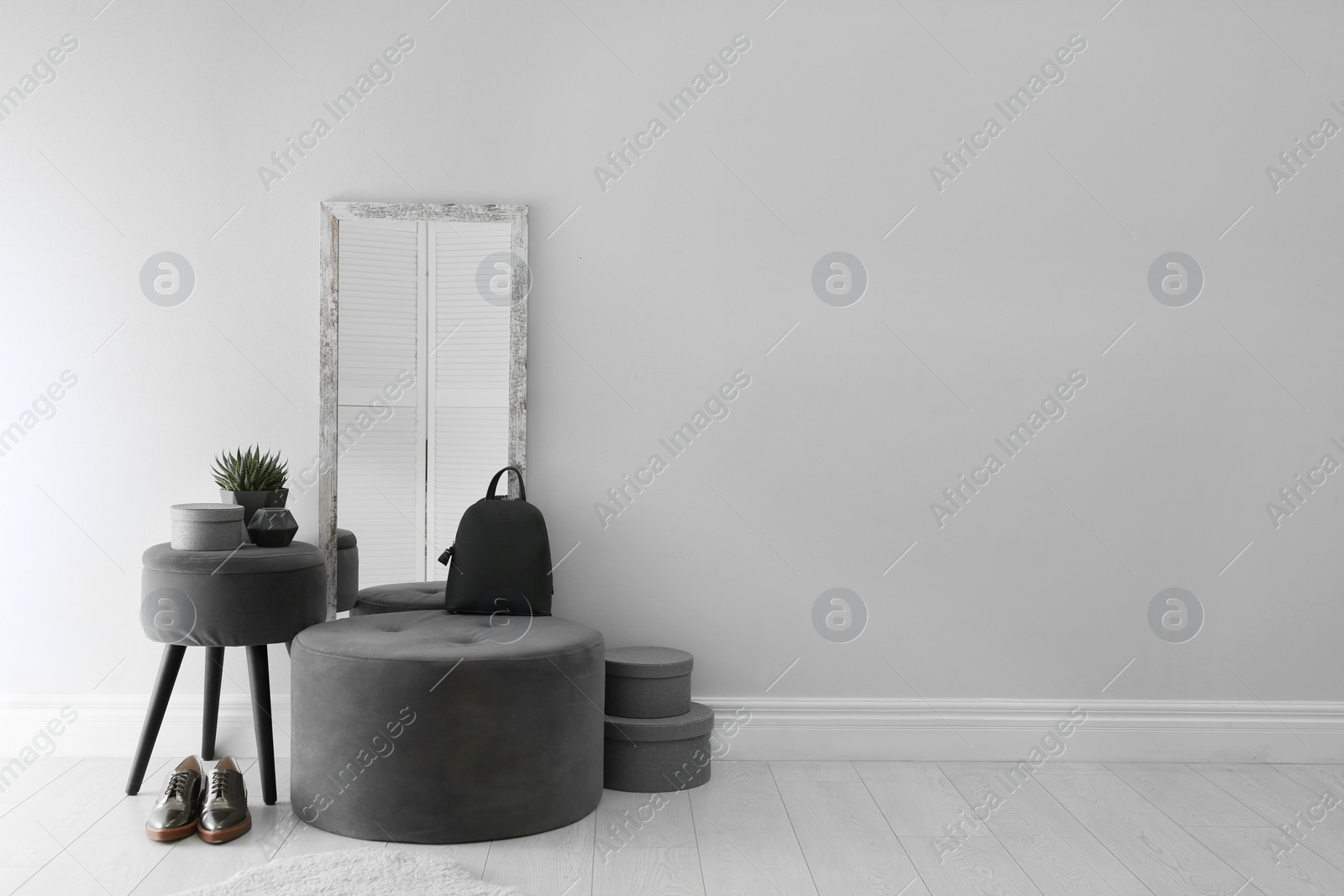 Photo of Large stylish mirror near light wall in room. Space for text