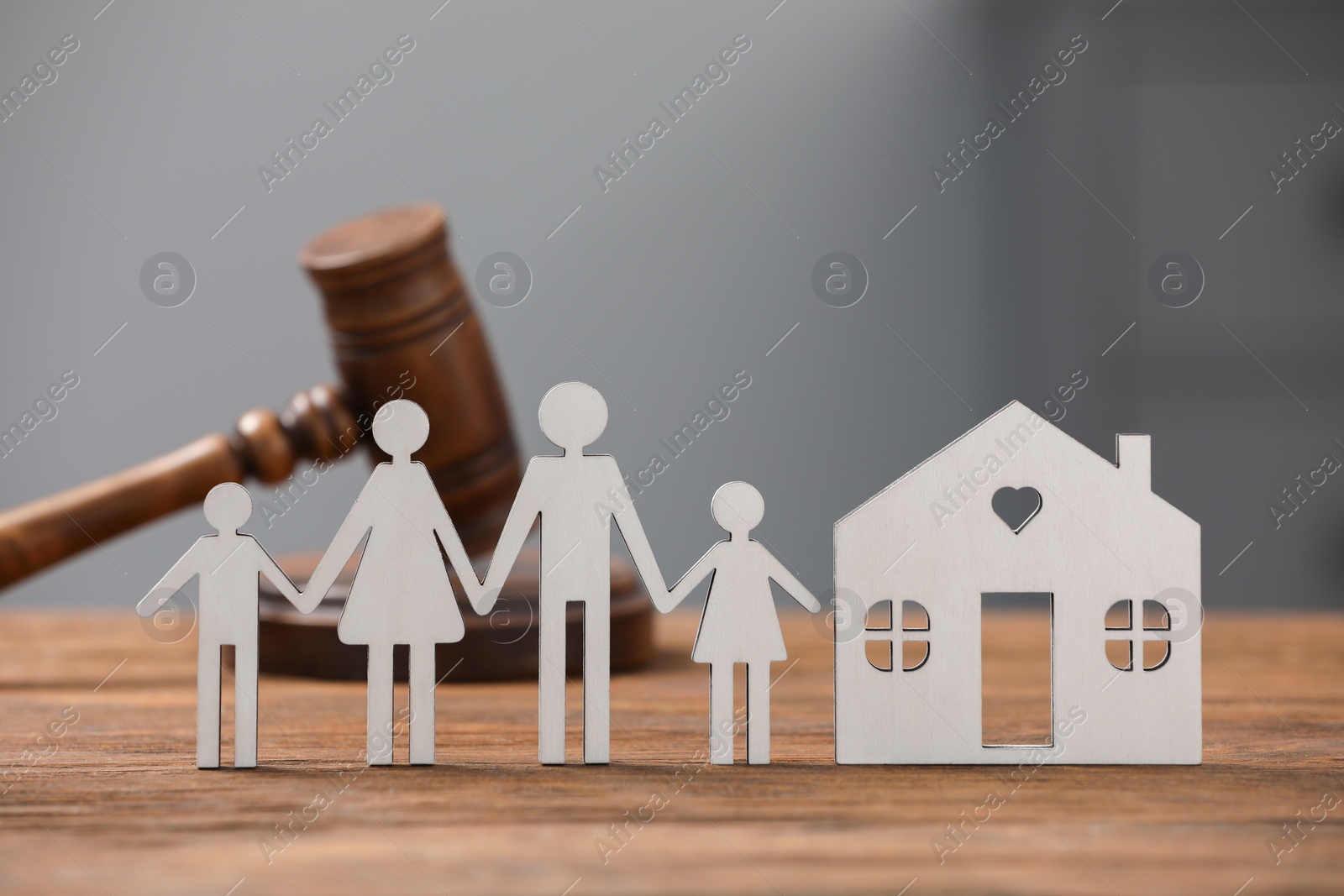 Photo of Family law. Figure of parents with children, house model and gavel on wooden table