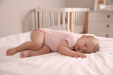 Photo of Adorable little baby sleeping on bed at home