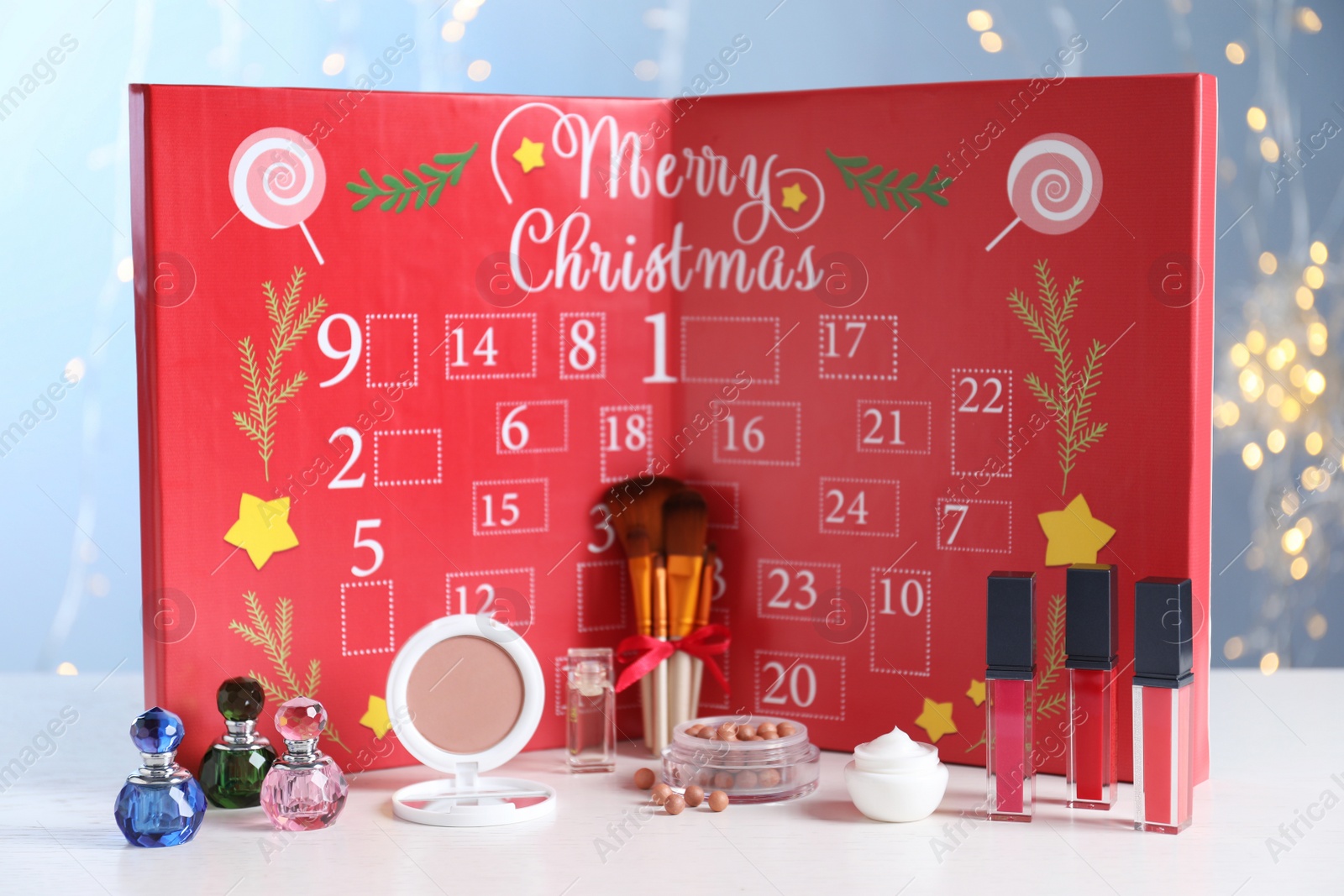 Christmas advent calendar with perfumes, skin care and decorative cosmetics on table Photo of Christmas advent calendar with perfumes, skin care and decorative cosmetics on table