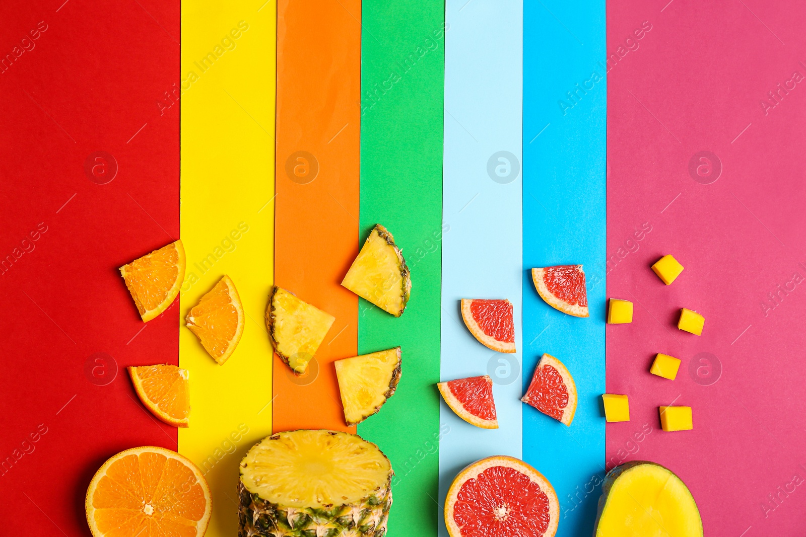 Photo of Rainbow composition with fresh fruits on color background, flat lay