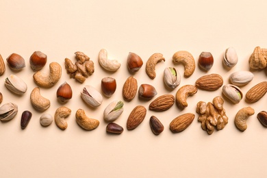 Photo of Flat lay composition with organic mixed nuts on color background
