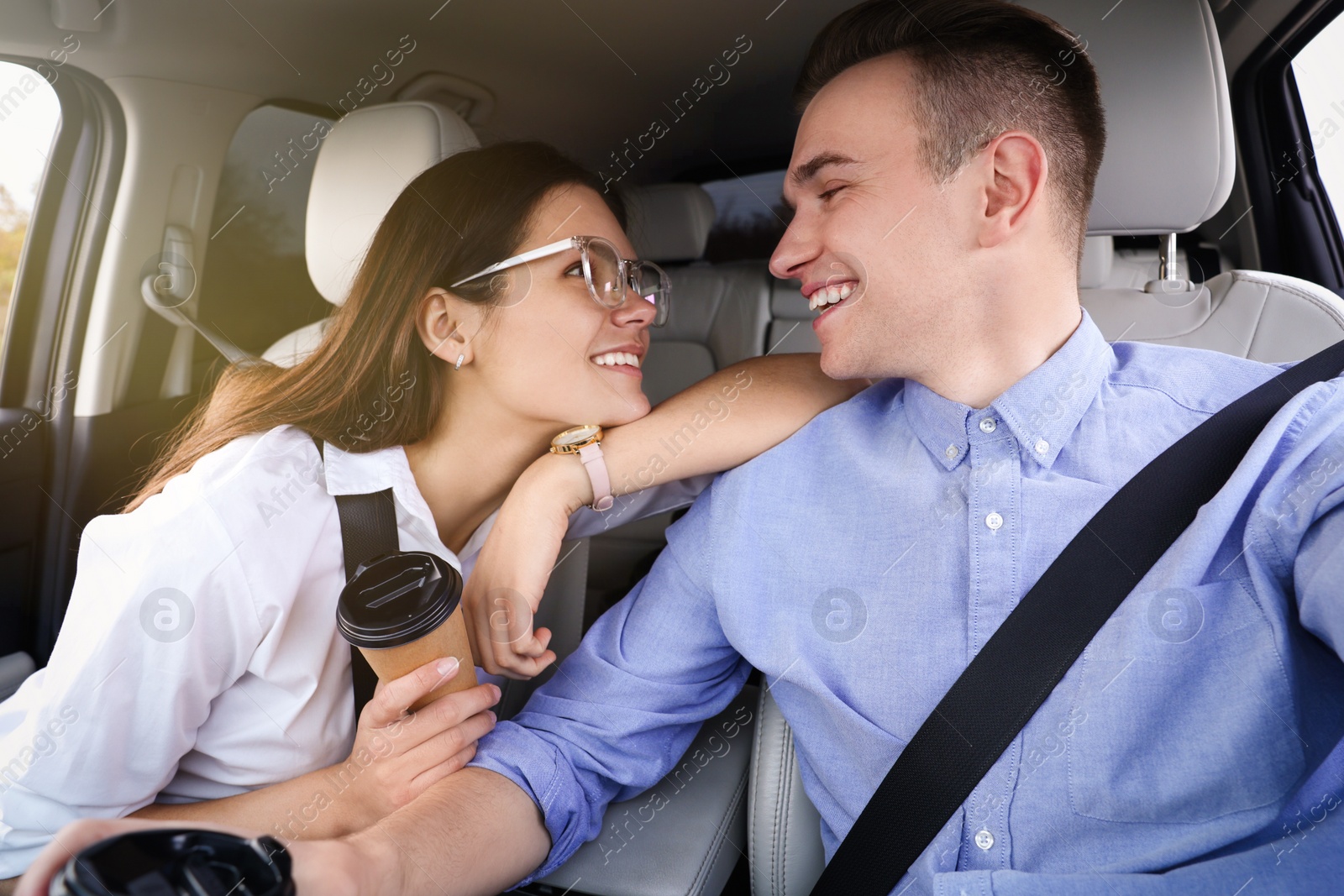 Photo of Happy young couple travelling together by car