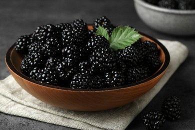 Bowl with fresh ripe blackberries on dark grey table, closeup