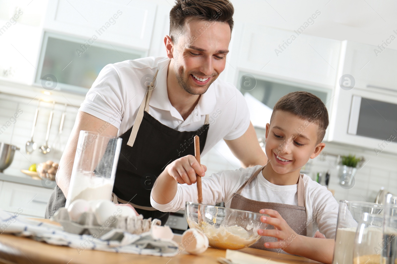 Photo of Dad and son cooking together in kitchen