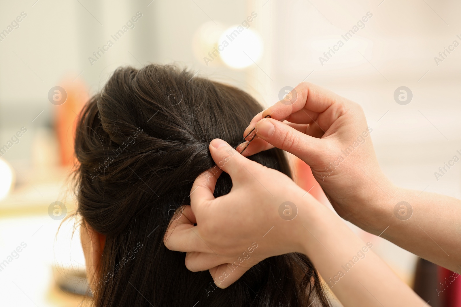 Photo of Hair styling. Professional hairdresser working with client indoors, closeup