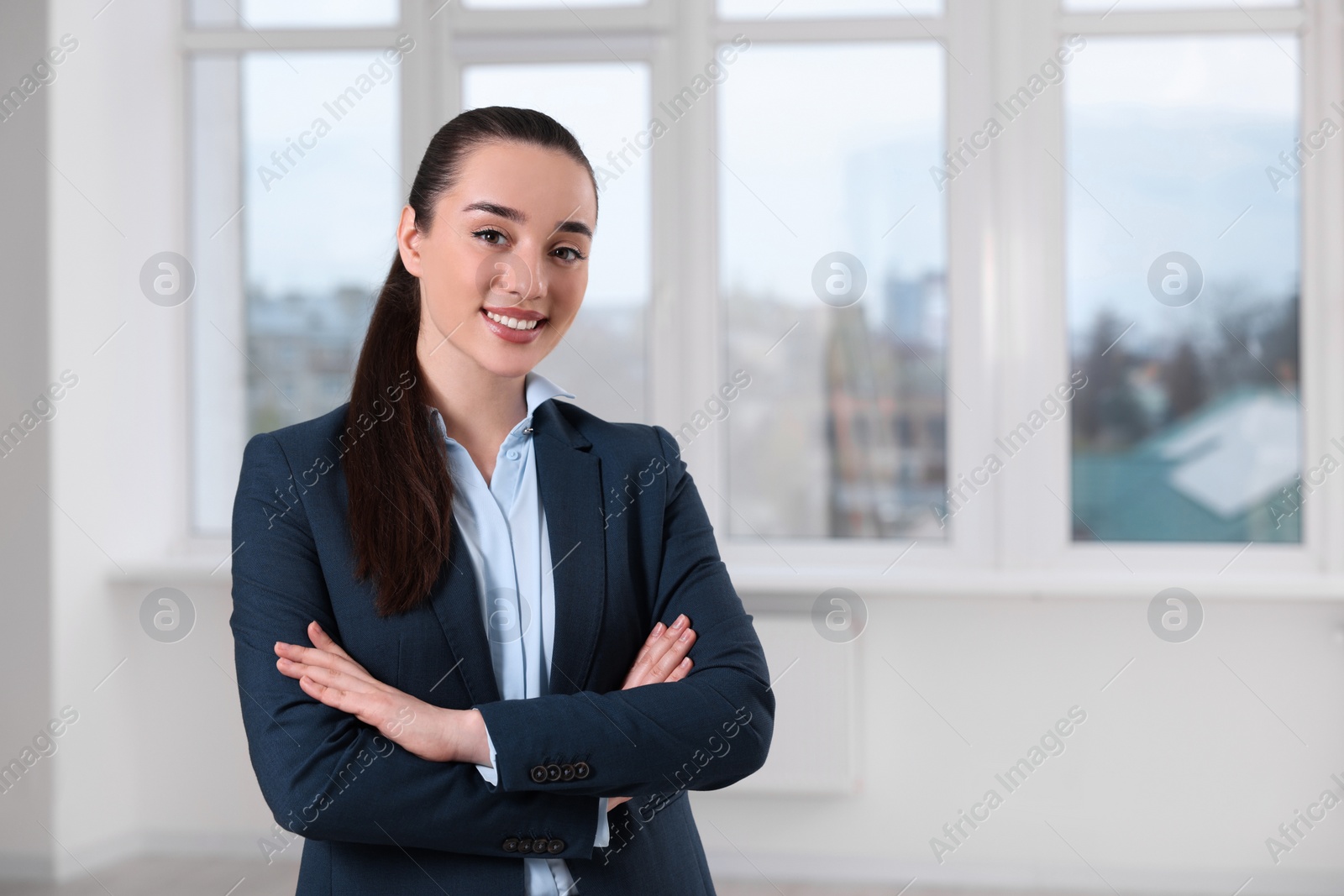 Photo of Happy real estate agent in new apartment. Space for text