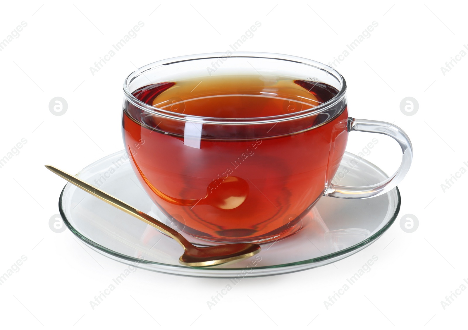 Photo of Aromatic tea in glass cup and golden spoon isolated on white