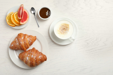 Tasty breakfast served on white wooden table, flat lay