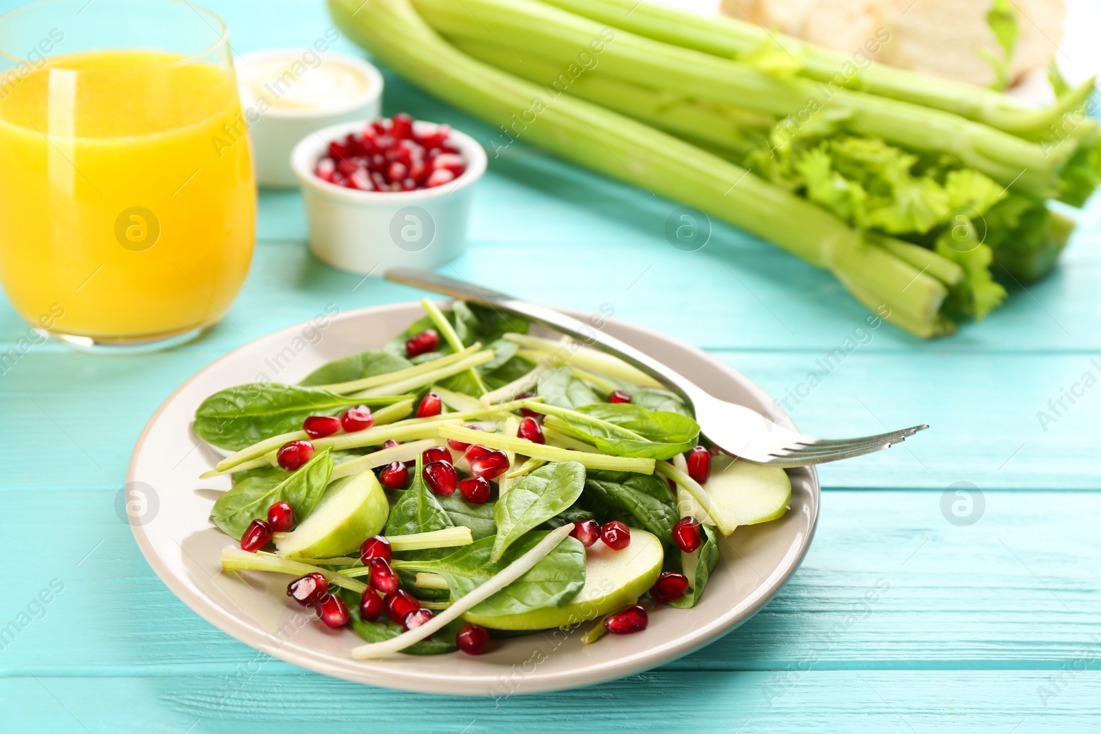 Photo of Delicious fresh celery salad on light blue wooden table