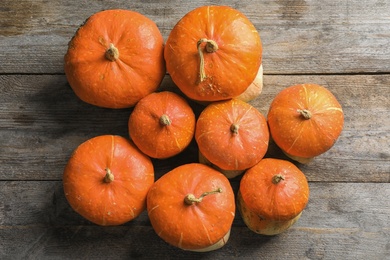 Orange pumpkins on wooden background, flat lay composition. Autumn holidays