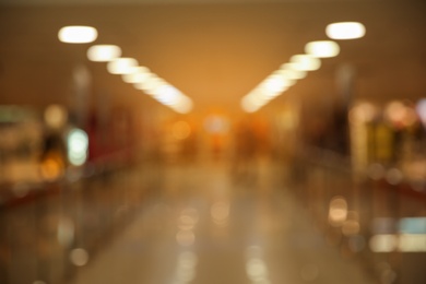 Photo of Blurred view of modern shopping mall interior