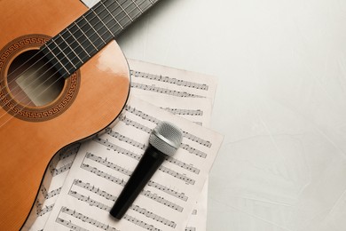 Photo of Composition with guitar and music notations on light table, flat lay. Space for text
