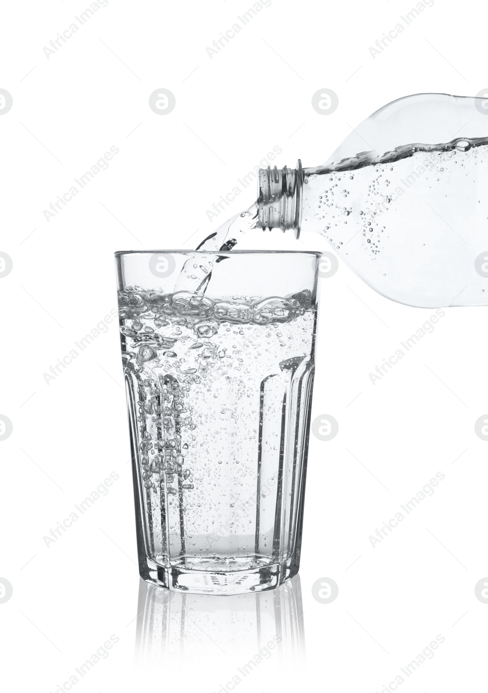 Photo of Pouring soda water from bottle into glass on white background