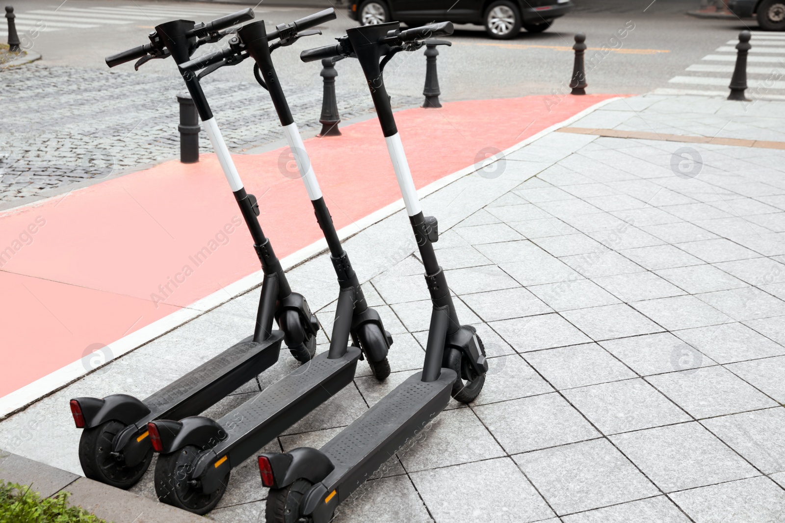 Photo of Row of electric scooters outdoors. Rental service