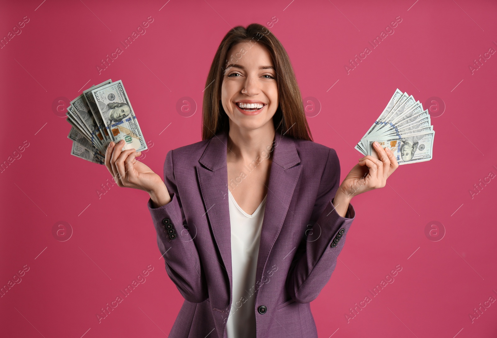 Photo of Happy young woman with cash money on pink background