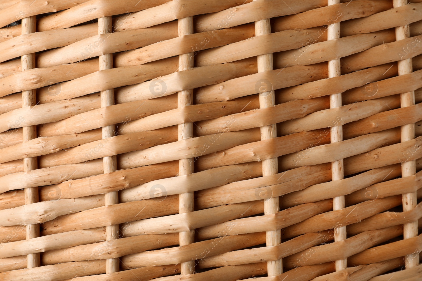 Photo of Handmade wicker basket made of natural material as background, closeup view