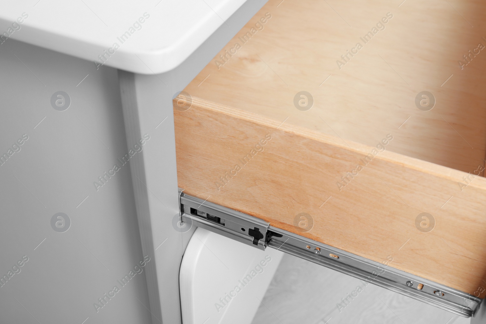 Photo of Open chest of drawers indoors, closeup view