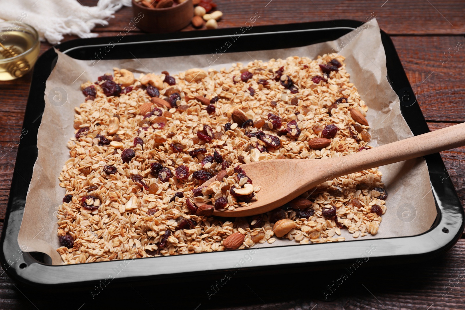 Photo of Tray with tasty granola, nuts and dry fruits on wooden table