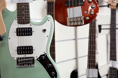 Photo of Modern electric guitar in music store, closeup