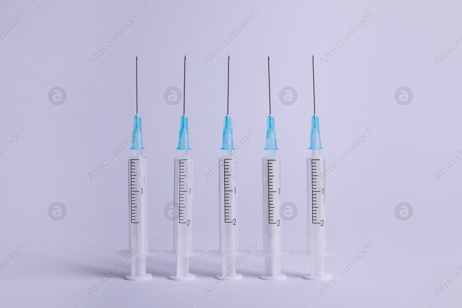 Photo of Disposable syringes with needles on white background