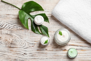 Flat lay composition with cosmetic products on wooden background