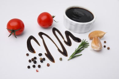 Organic balsamic vinegar and cooking ingredients on white background