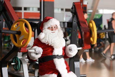 Photo of Authentic Santa Claus training in modern gym