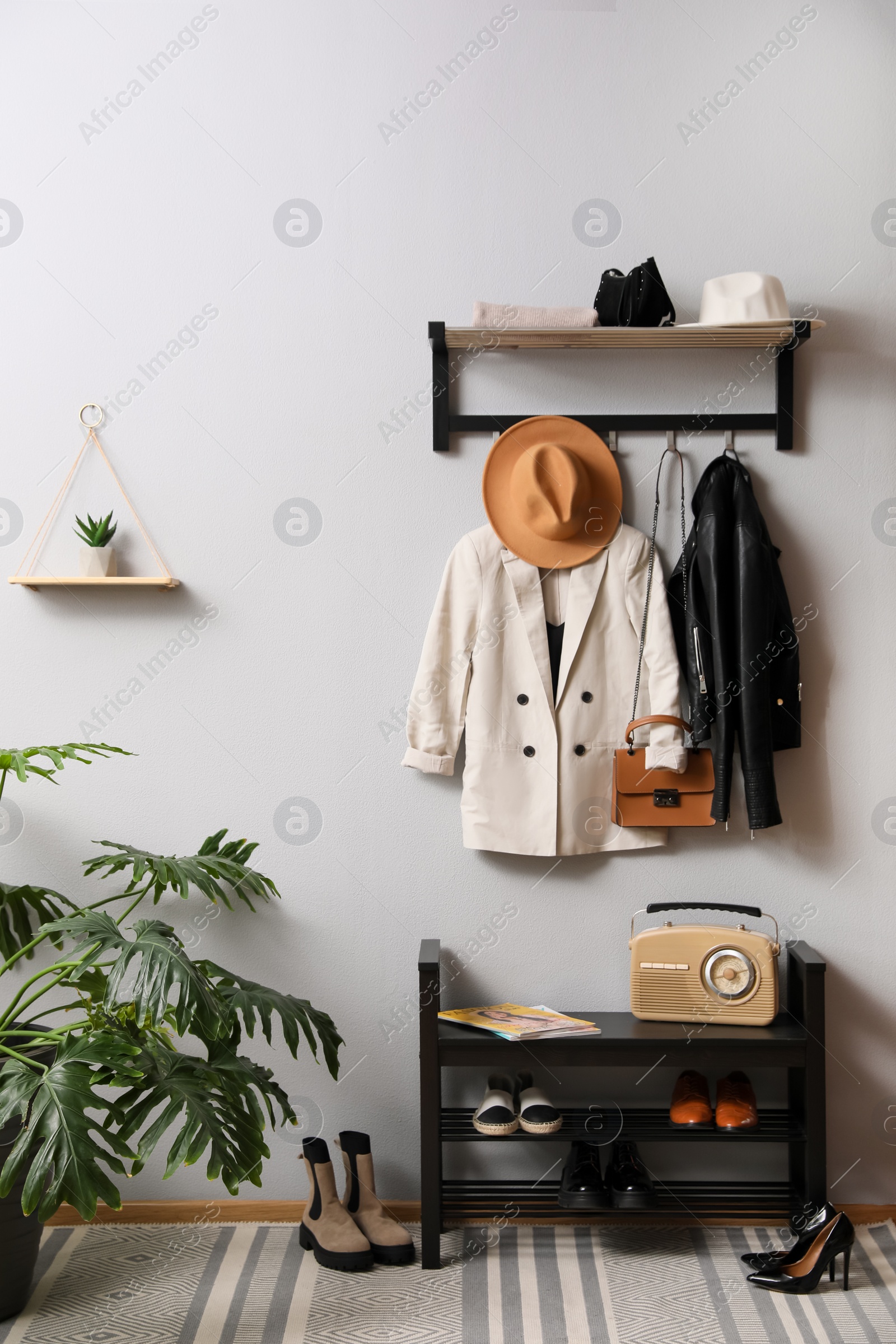 Photo of Hallway interior with stylish furniture, clothes and accessories