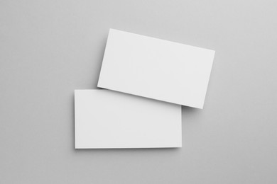 Photo of Blank business cards on light gray background, top view. Mockup for design