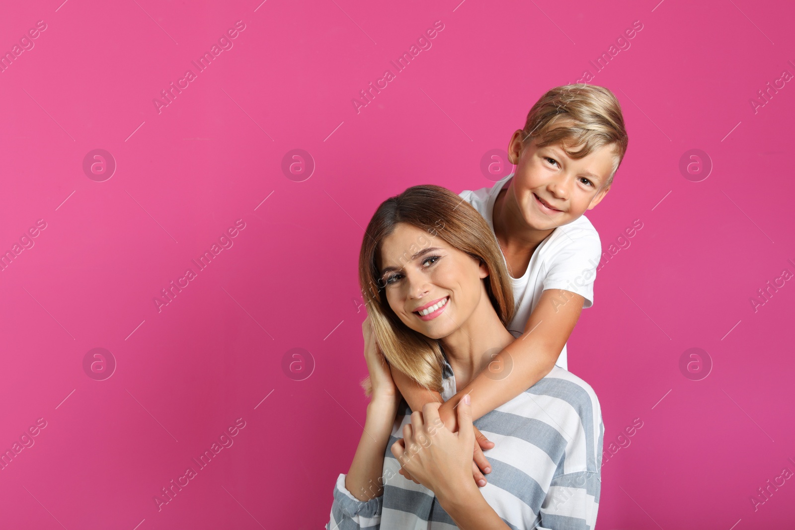 Photo of Portrait of mother and son on color background