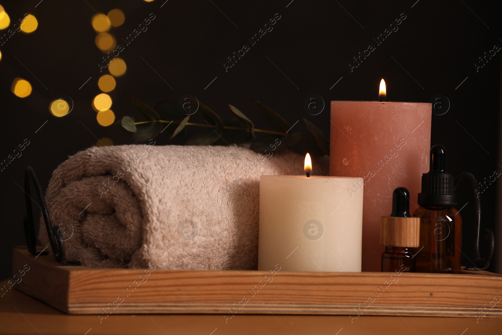 Photo of Beautiful composition with different spa products on wooden table against blurred lights