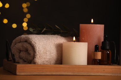 Photo of Beautiful composition with different spa products on wooden table against blurred lights