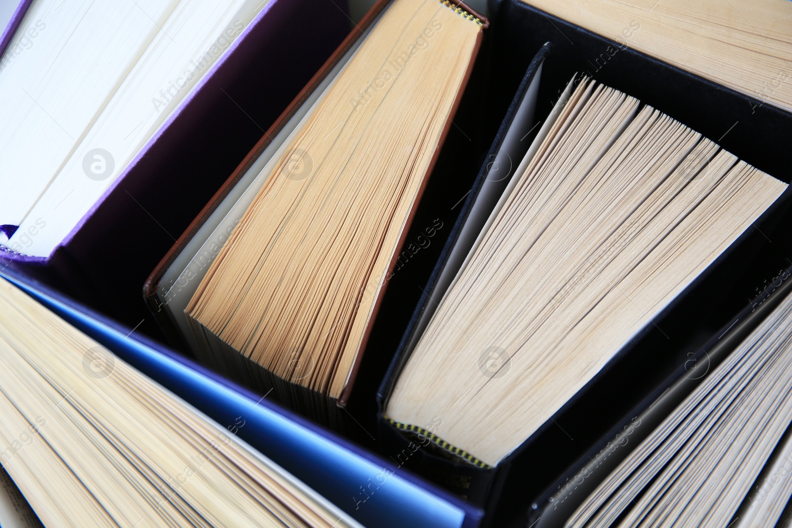 Photo of Collection of different hardcover books, closeup view