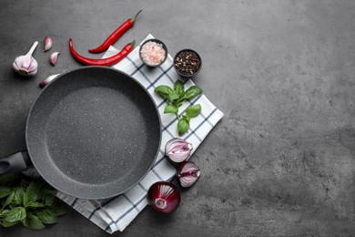 Photo of Flat lay composition with frying pan and fresh products on grey table, space for text